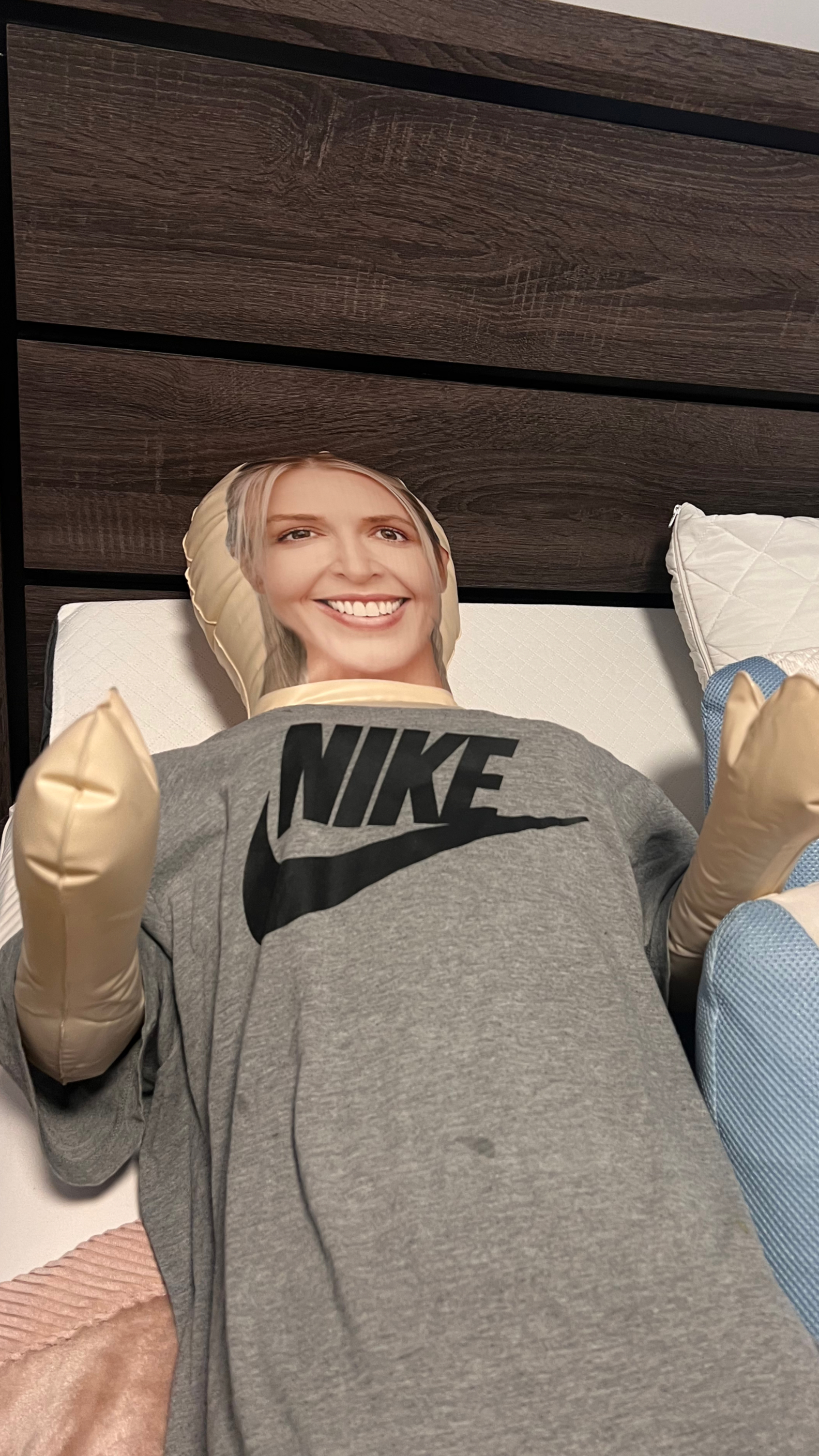 Inflatable Gerty lying in a bed, dressed in clothes